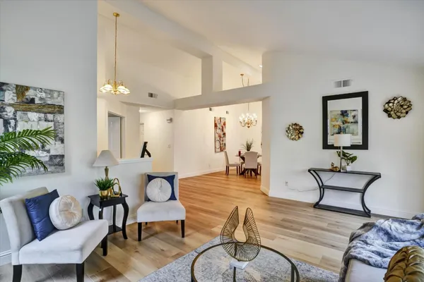 a living room with furniture and wooden floor