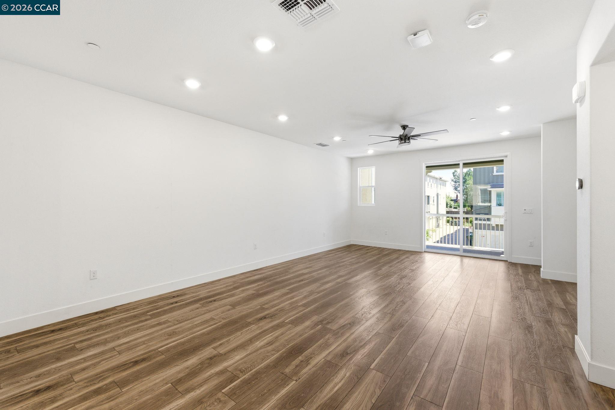 205 Plum Tree Street Livermore, CA 94551 - Photo 15 of 47 an empty room with wooden floor and windows