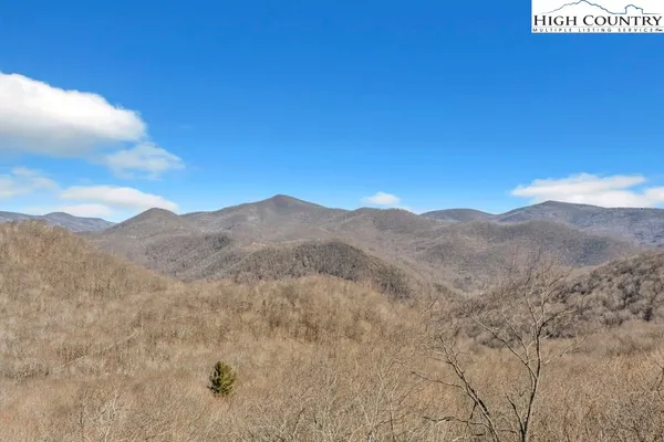 a view of a large mountain with a mountain in the background