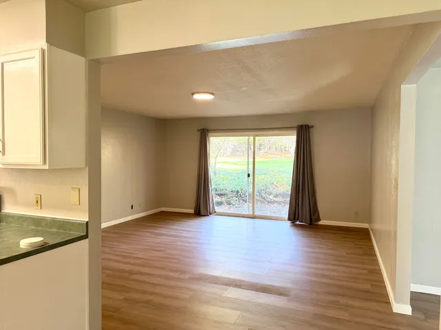 a bedroom with a balcony a bed and a painting on the wall