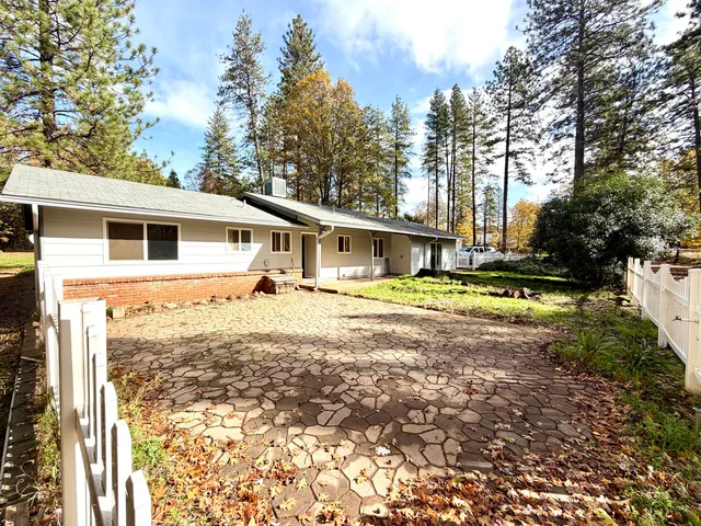 a large white kitchen with wooden floors