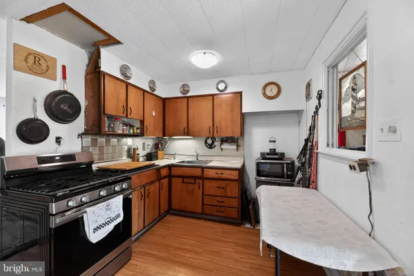 a kitchen with a stove a sink and a cabinets