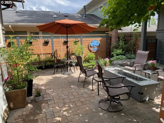 a view of a backyard with sitting area and furniture