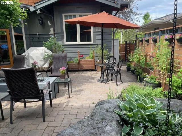 a view of a patio with table and chairs under an umbrella