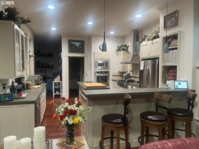 a kitchen with cabinets and chairs