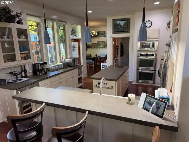 a kitchen with a table chairs and a refrigerator