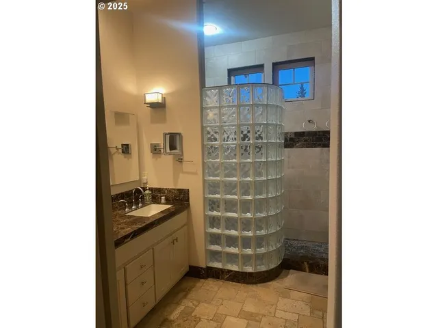 a bathroom with a granite countertop sink and a blue