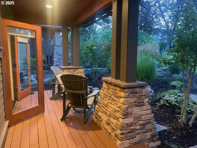 a view of a balcony with furniture and wooden floor