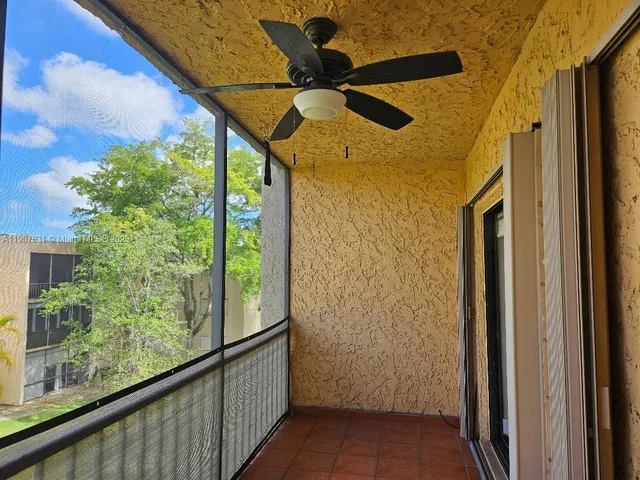 a yellow room with wooden floor and windows