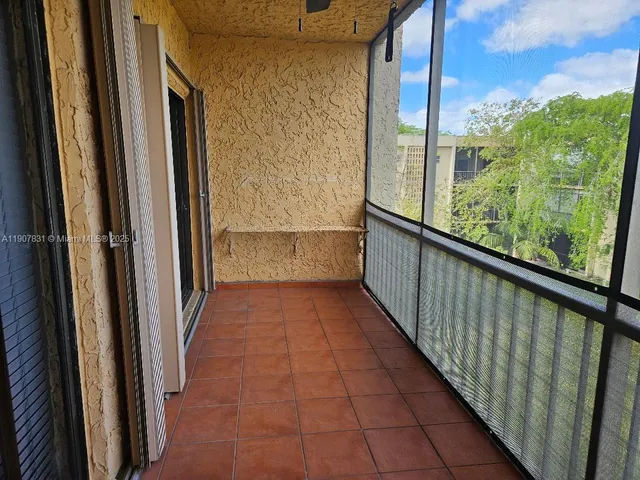 a view of a balcony with wooden floor