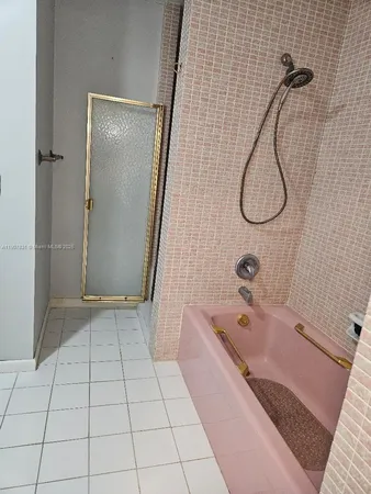 a bathroom with a bathtub and shower