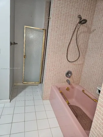 a bathroom with a bathtub and shower
