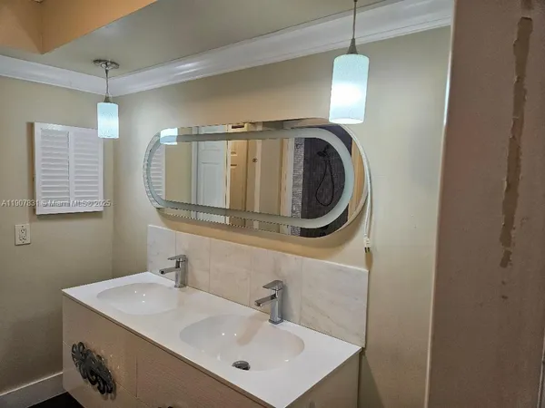 a bathroom with a sink a mirror and a toilet