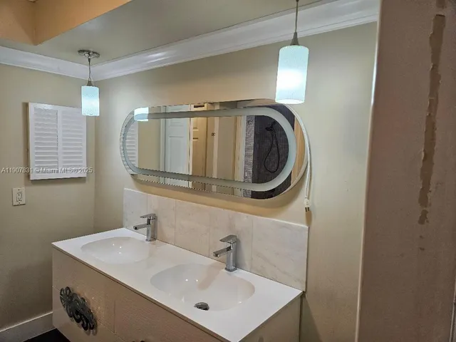 a bathroom with a sink a mirror and a toilet