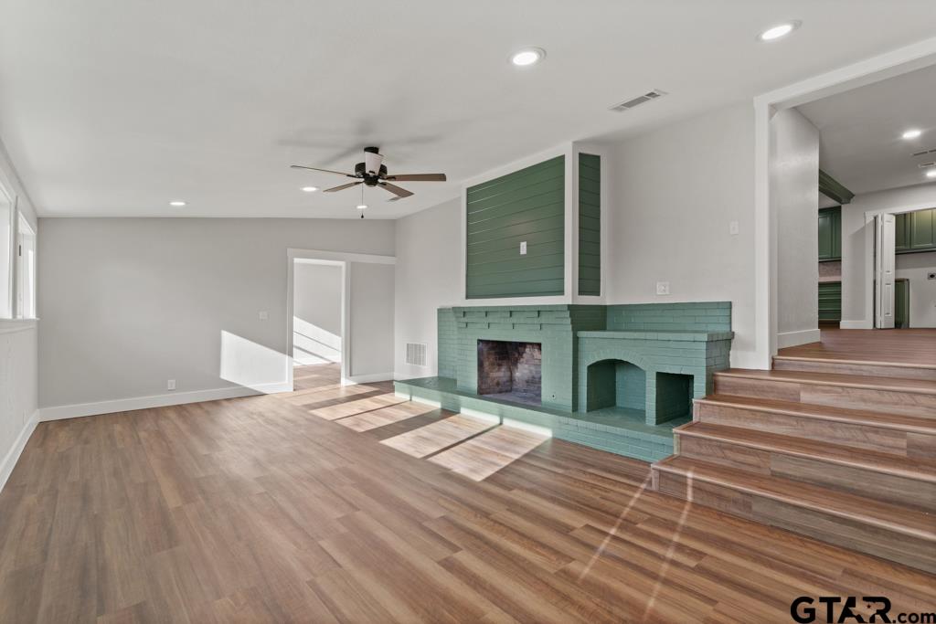 2819 New Copeland Road Tyler, TX 75701 - Photo 13 of 39 a view of a livingroom with a fireplace a chandelier and wooden floor