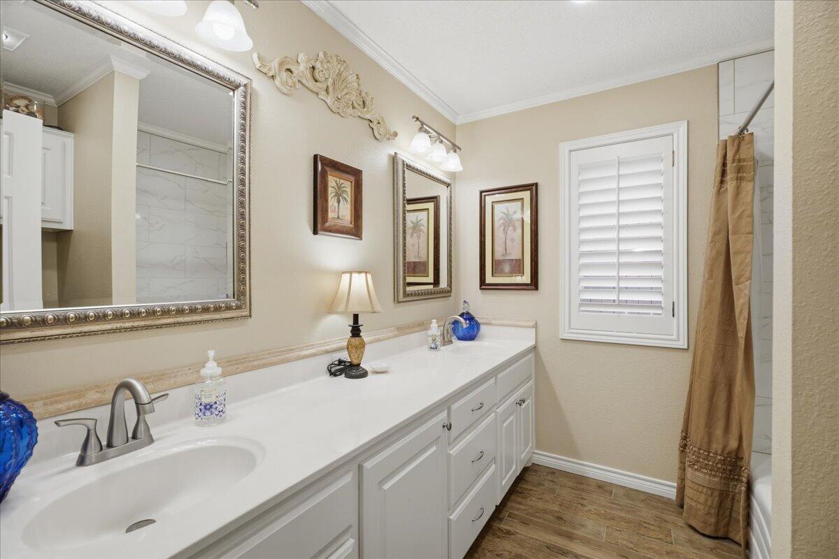 4612 100th Street Lubbock, TX 79424 - Photo 41 of 55 a bathroom with a double vanity sink and a mirror