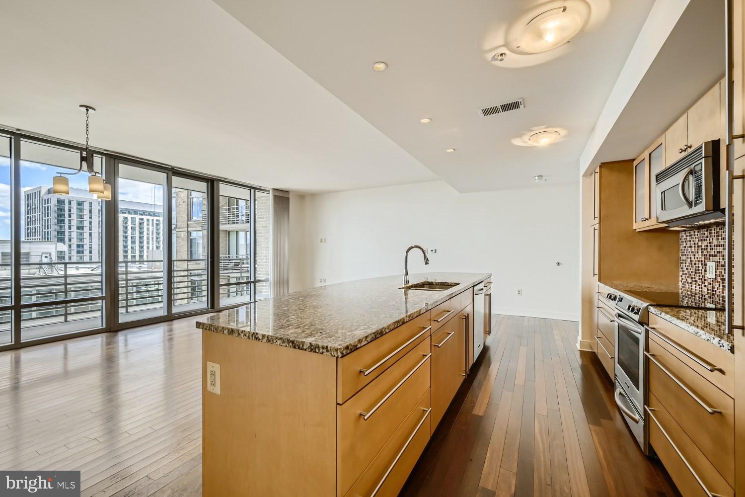 675 President Street, Unit 1709 Baltimore, MD 21202 - Photo 5 of 33 a kitchen with stainless steel appliances granite countertop a stove and a sink