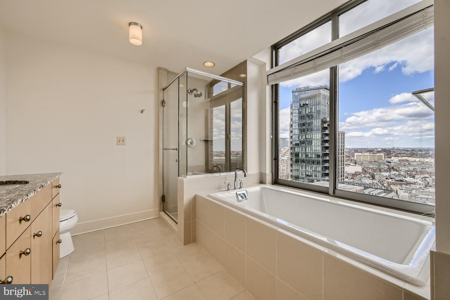 675 President Street, Unit 1709 Baltimore, MD 21202 - Photo 7 of 33 a bathroom with a bathtub and a shower