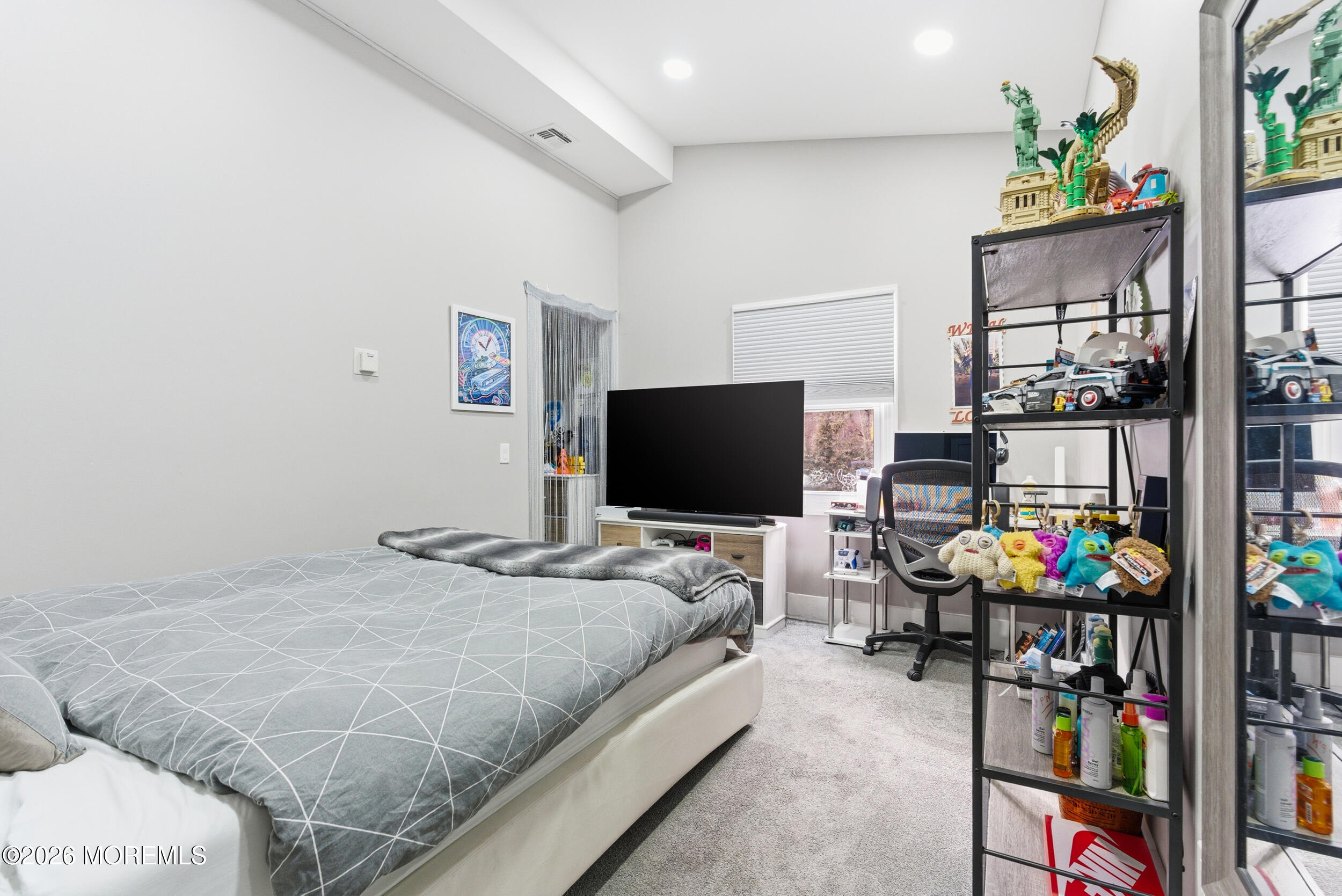 612 Deal Road Asbury Park, NJ 07712 - Photo 30 of 48 a bedroom with bed a flat tv screen and a book shelf