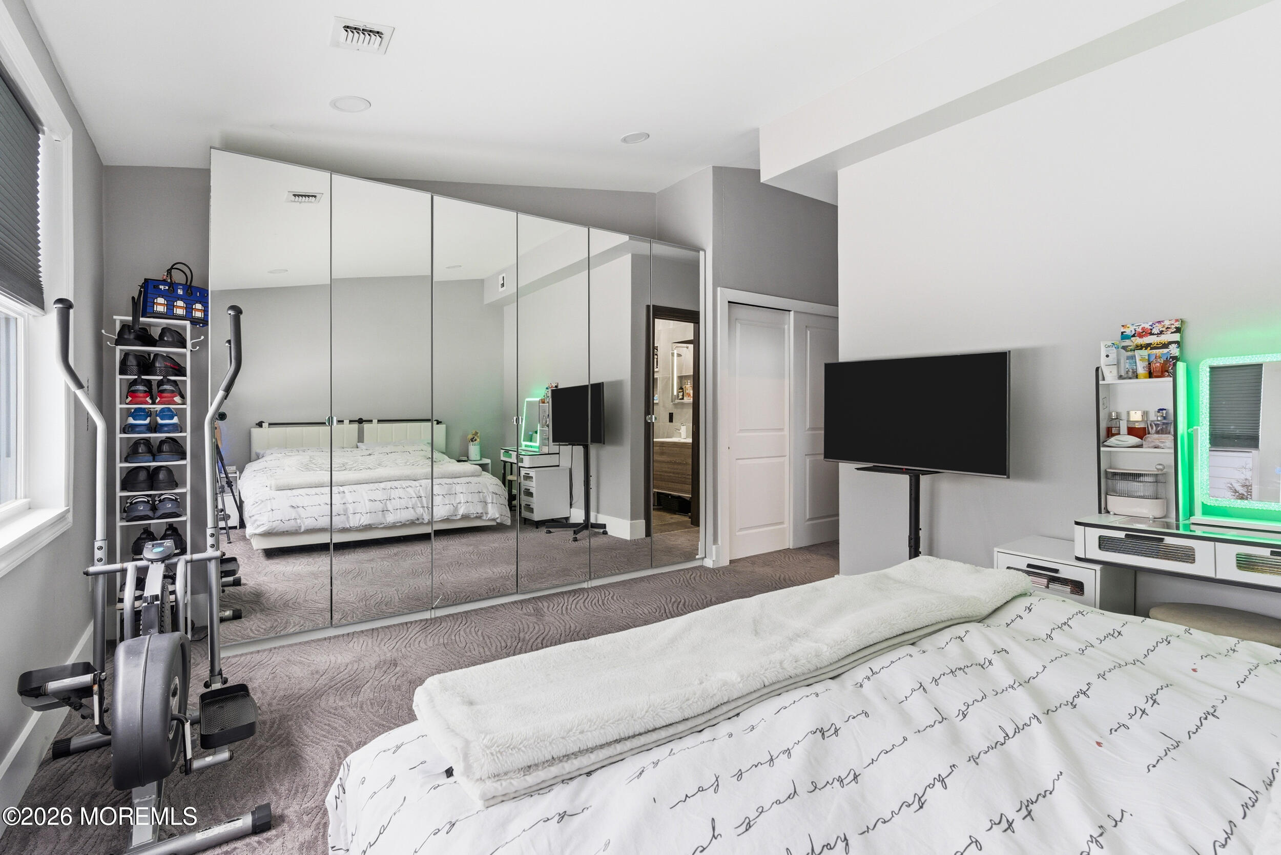 612 Deal Road Asbury Park, NJ 07712 - Photo 39 of 48 a bedroom with a bed and a flat tv screen on the dresser