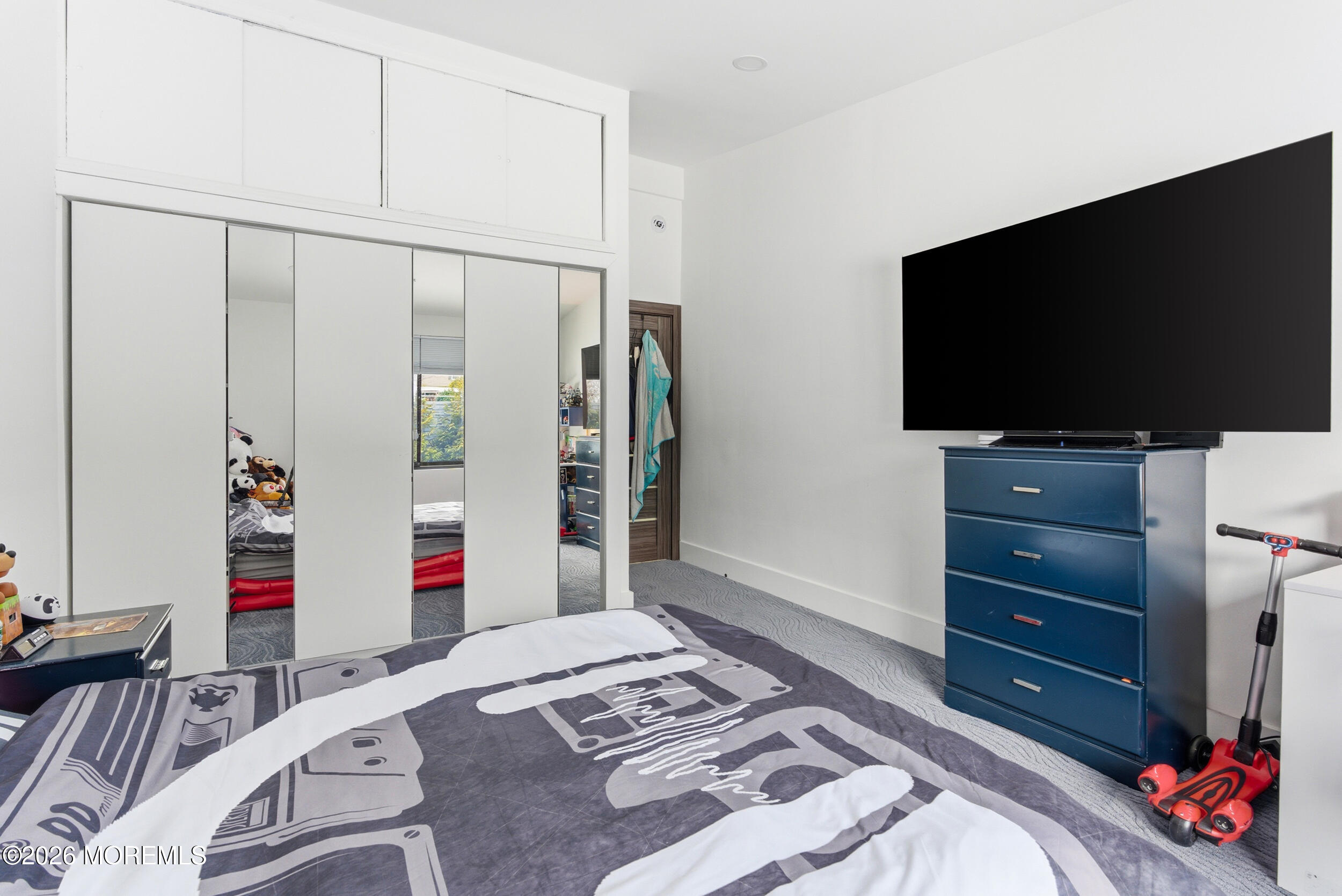 612 Deal Road Asbury Park, NJ 07712 - Photo 45 of 48 a bedroom with a bed and a flat screen tv