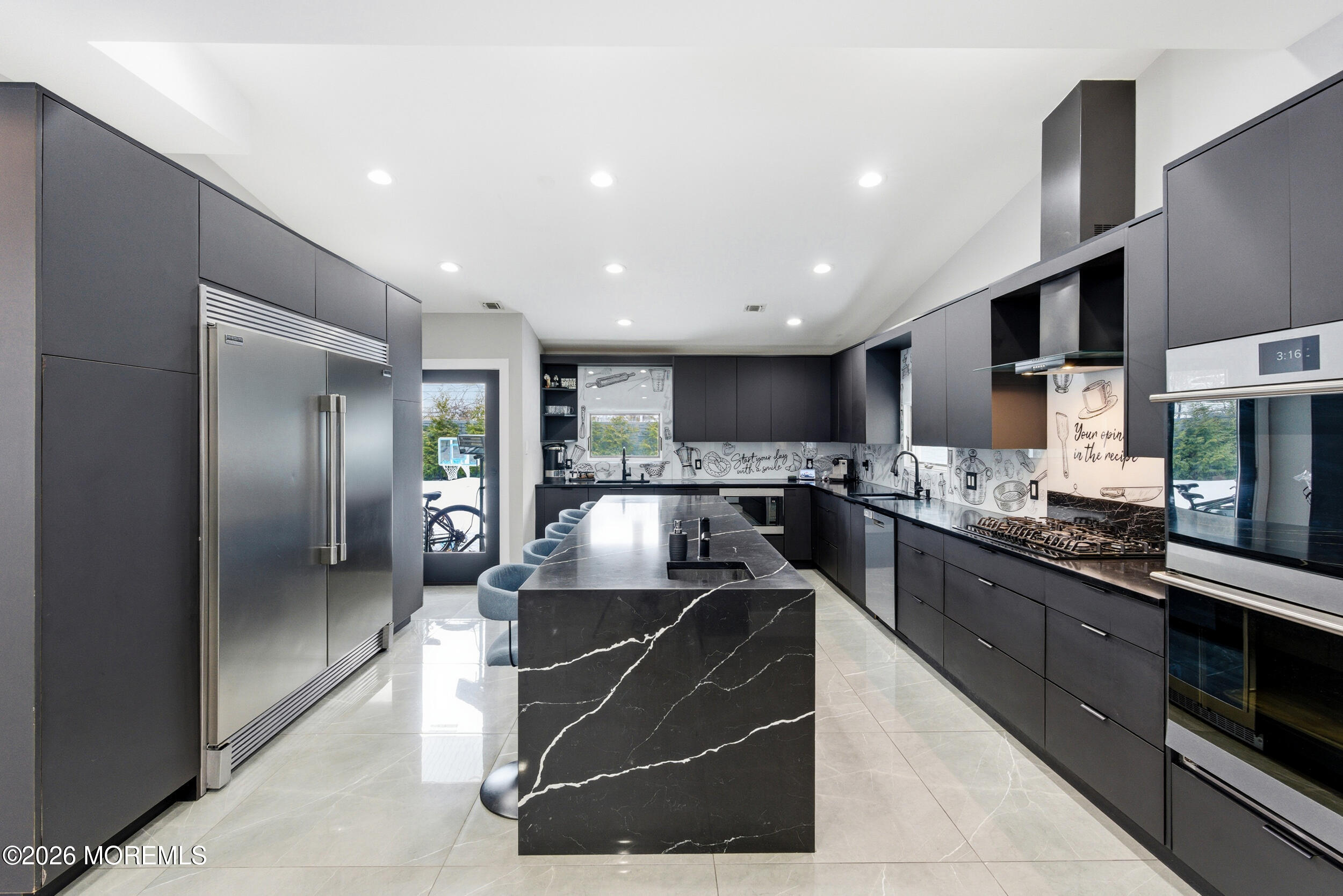 612 Deal Road Asbury Park, NJ 07712 - Photo 5 of 48 a kitchen with stainless steel appliances kitchen island granite countertop a sink and cabinets