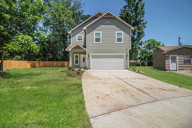 a front view of house with yard and green space