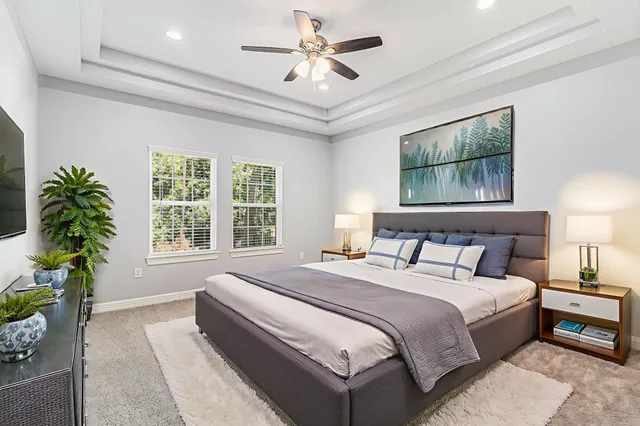 a bedroom with a large bed and a chandelier