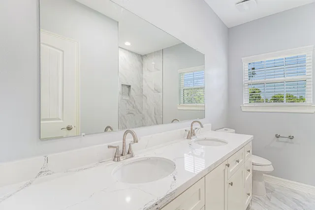 a bathroom with 2 sink and a bathtub