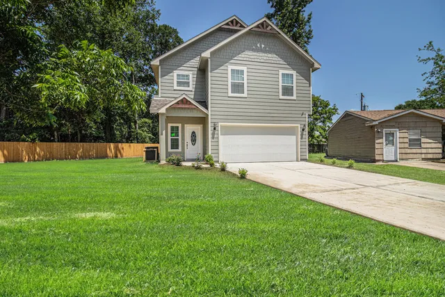 a front view of house with yard and green space