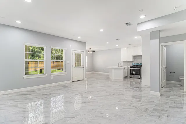 a view of kitchen with windows and refrigerator