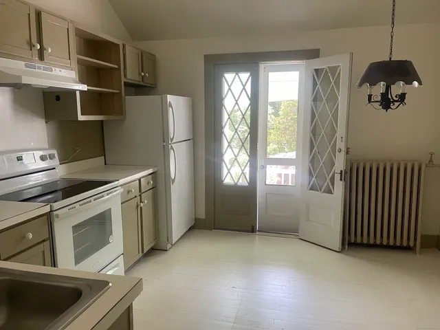 a kitchen that has a fridge and a stove