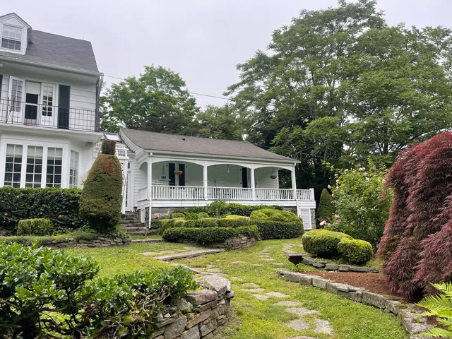 a front view of a house with a garden