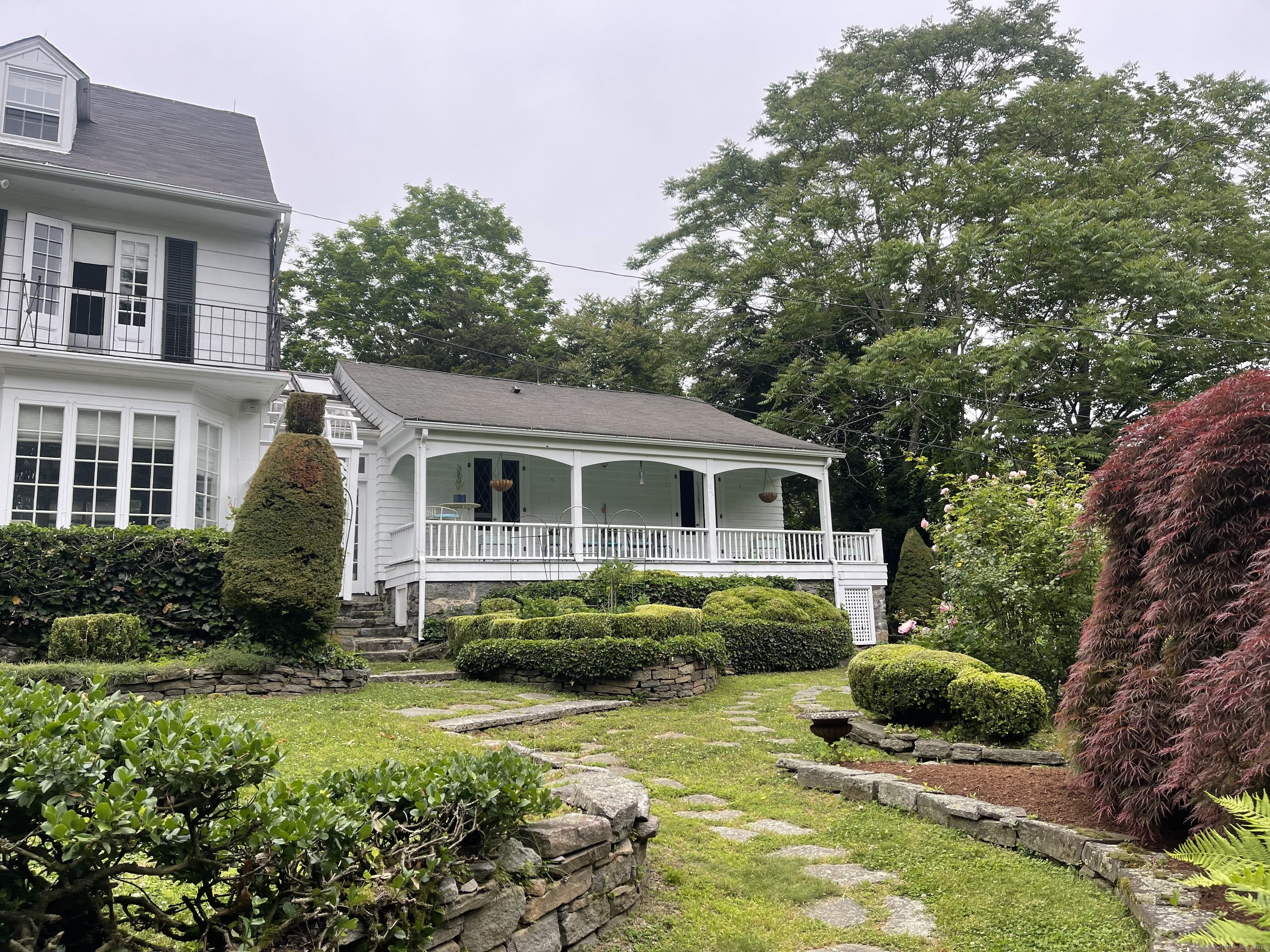 856 Boston Post Road, Unit 1 Madison, CT 06443 - Photo 14 of 25 a front view of a house with a garden