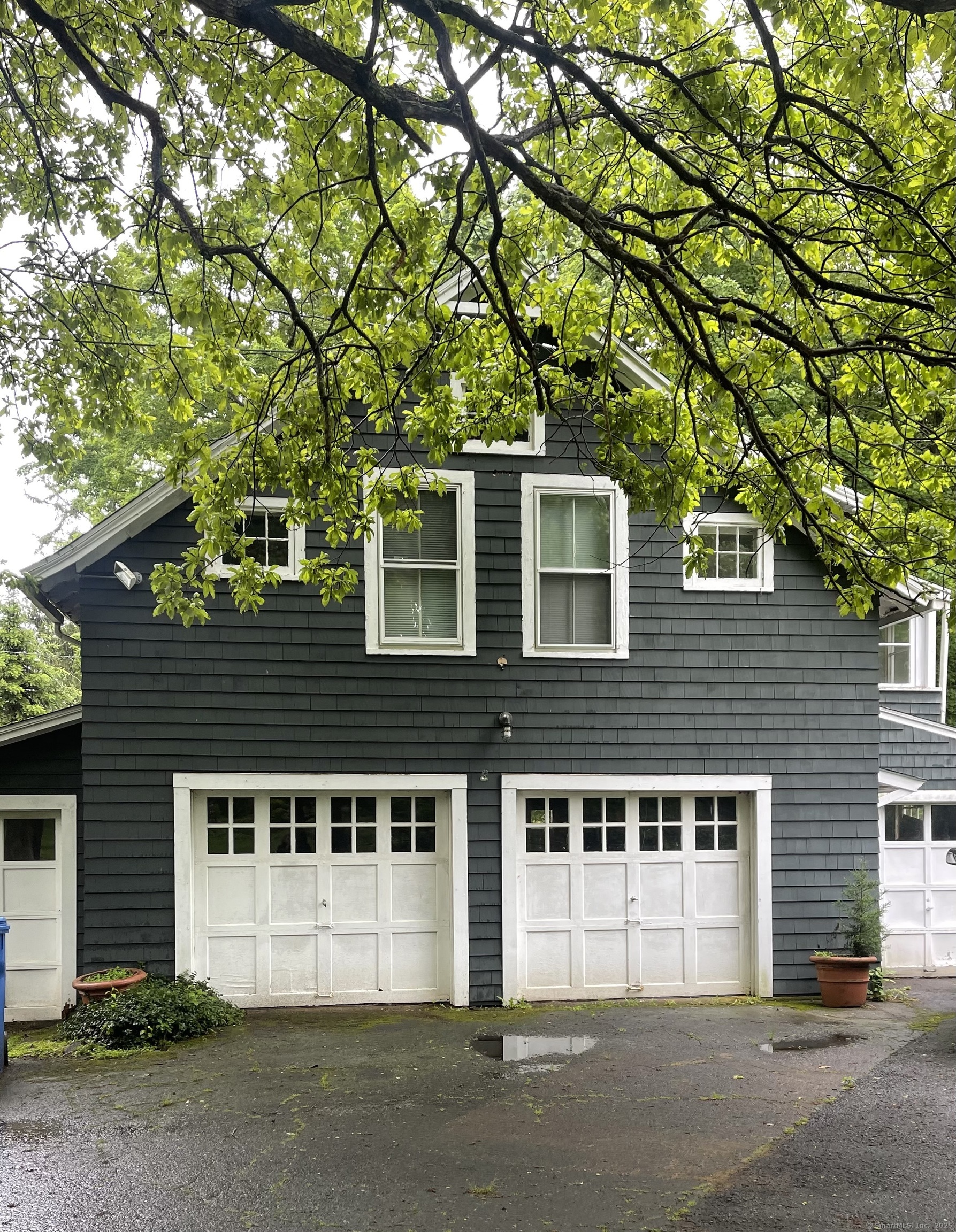 856 Boston Post Road, Unit 1 Madison, CT 06443 - Photo 16 of 25 a front view of a house with a yard and garage