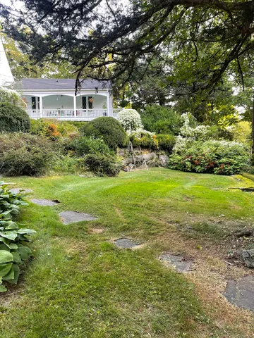 a front view of house with yard and green space
