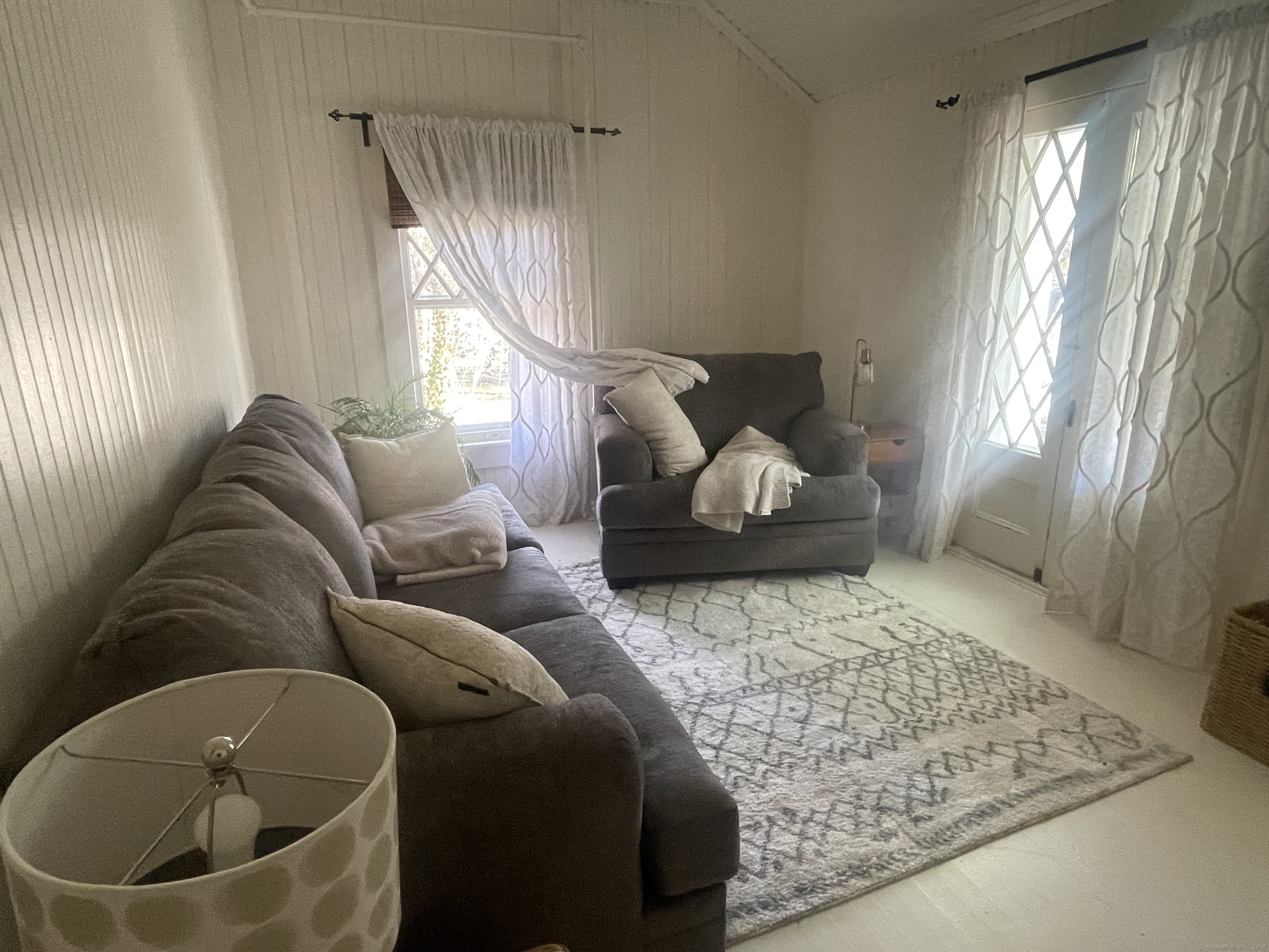 856 Boston Post Road, Unit 1 Madison, CT 06443 - Photo 20 of 25 a living room with furniture and a large window