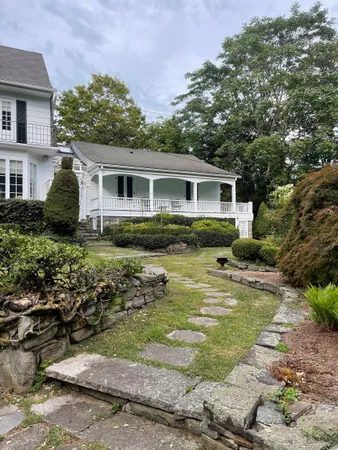 a view of a house with swimming pool and a yard