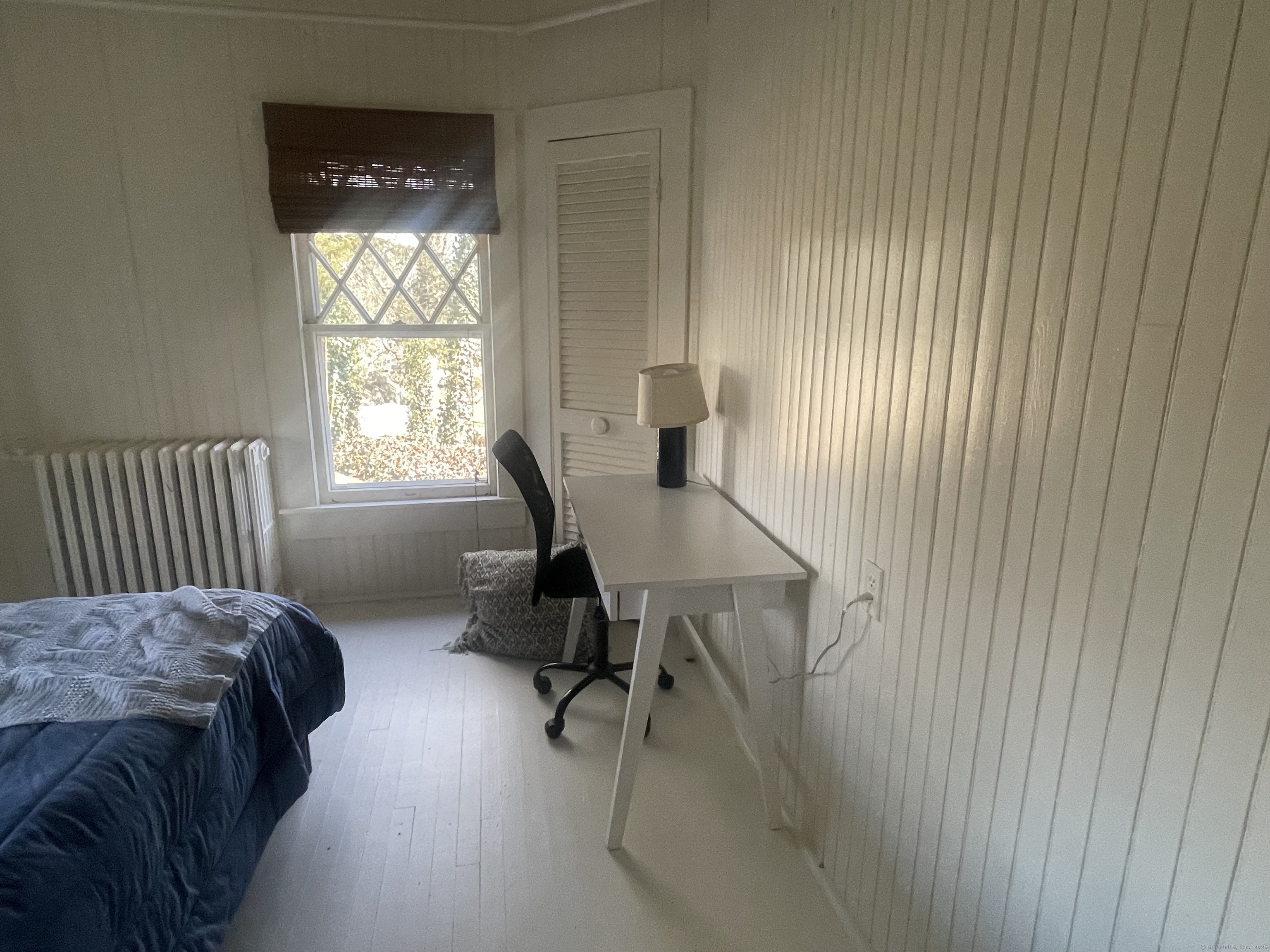 856 Boston Post Road, Unit 1 Madison, CT 06443 - Photo 22 of 25 a bedroom with a bed and a window