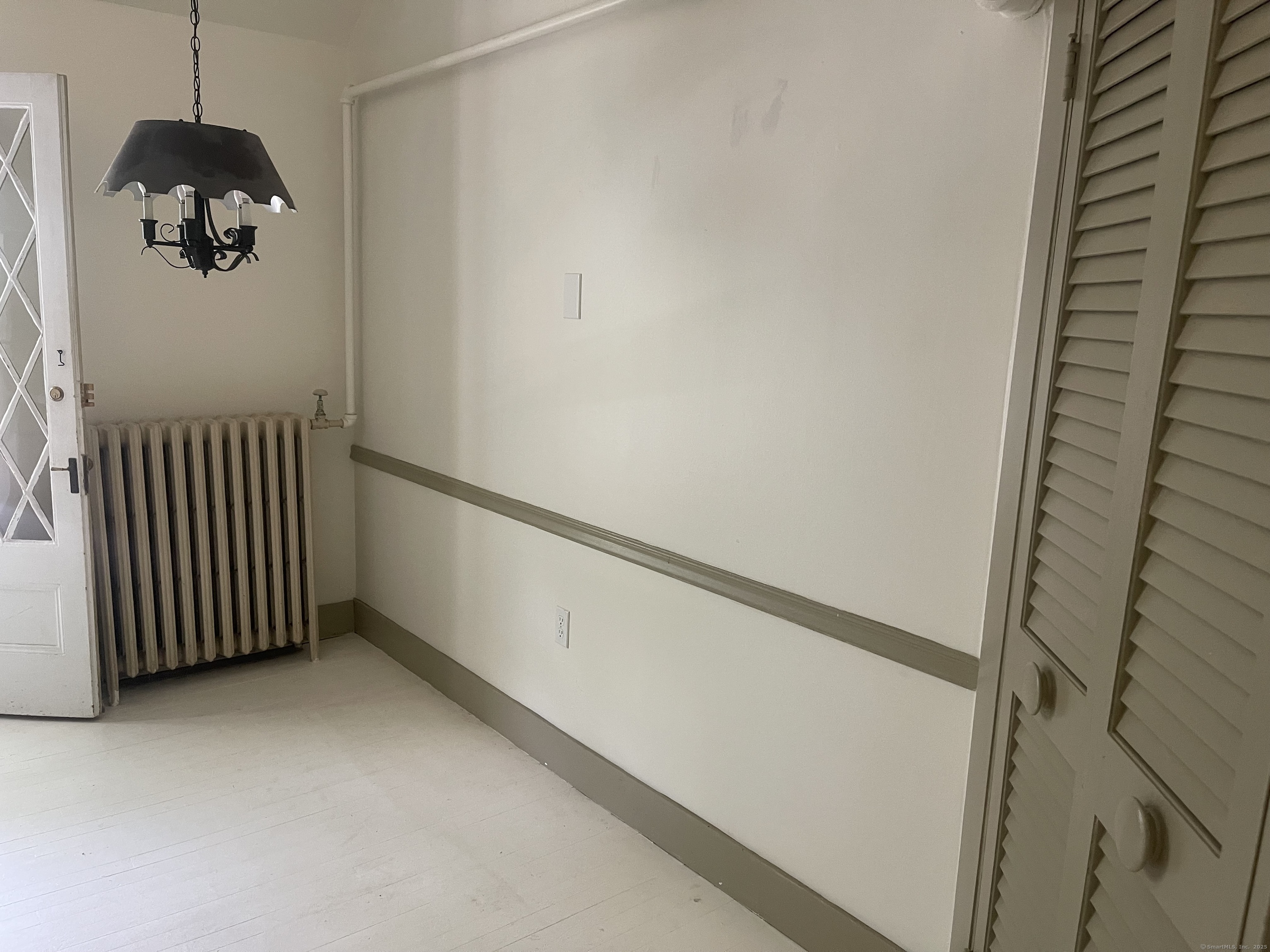 856 Boston Post Road, Unit 1 Madison, CT 06443 - Photo 10 of 25 a view of a hallway with a white door and a window