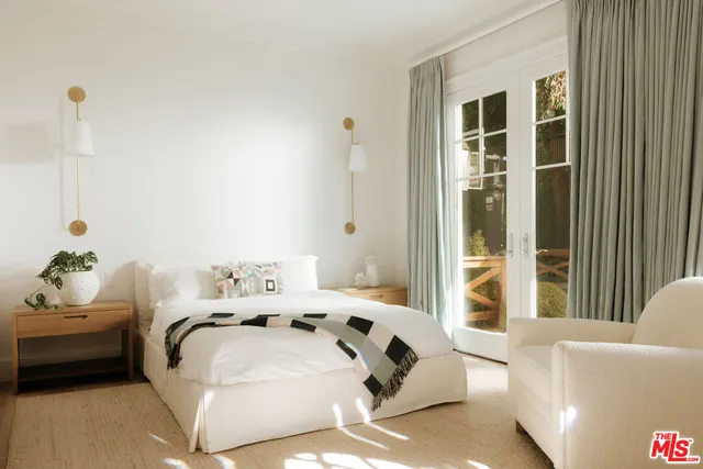 a bedroom with furniture and a window