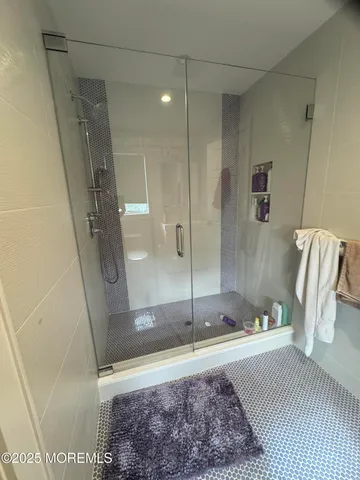 a bathroom with a bathtub and a shower