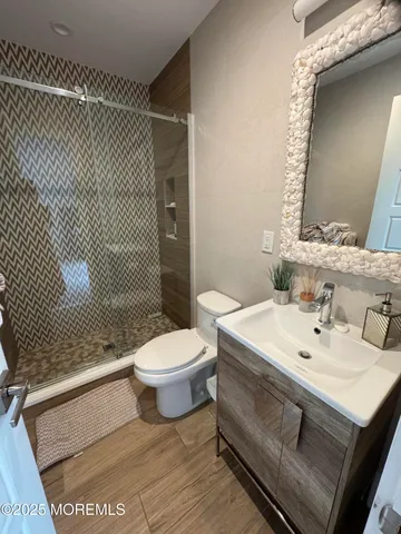 a bathroom with a sink toilet and shower