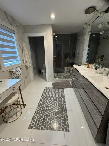 a bathroom with a sink a toilet and a mirror