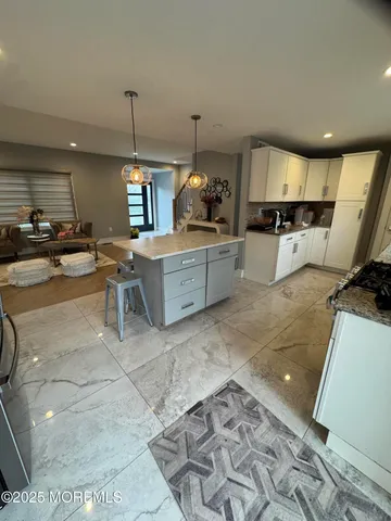 a kitchen with stainless steel appliances kitchen island granite countertop a sink and cabinets