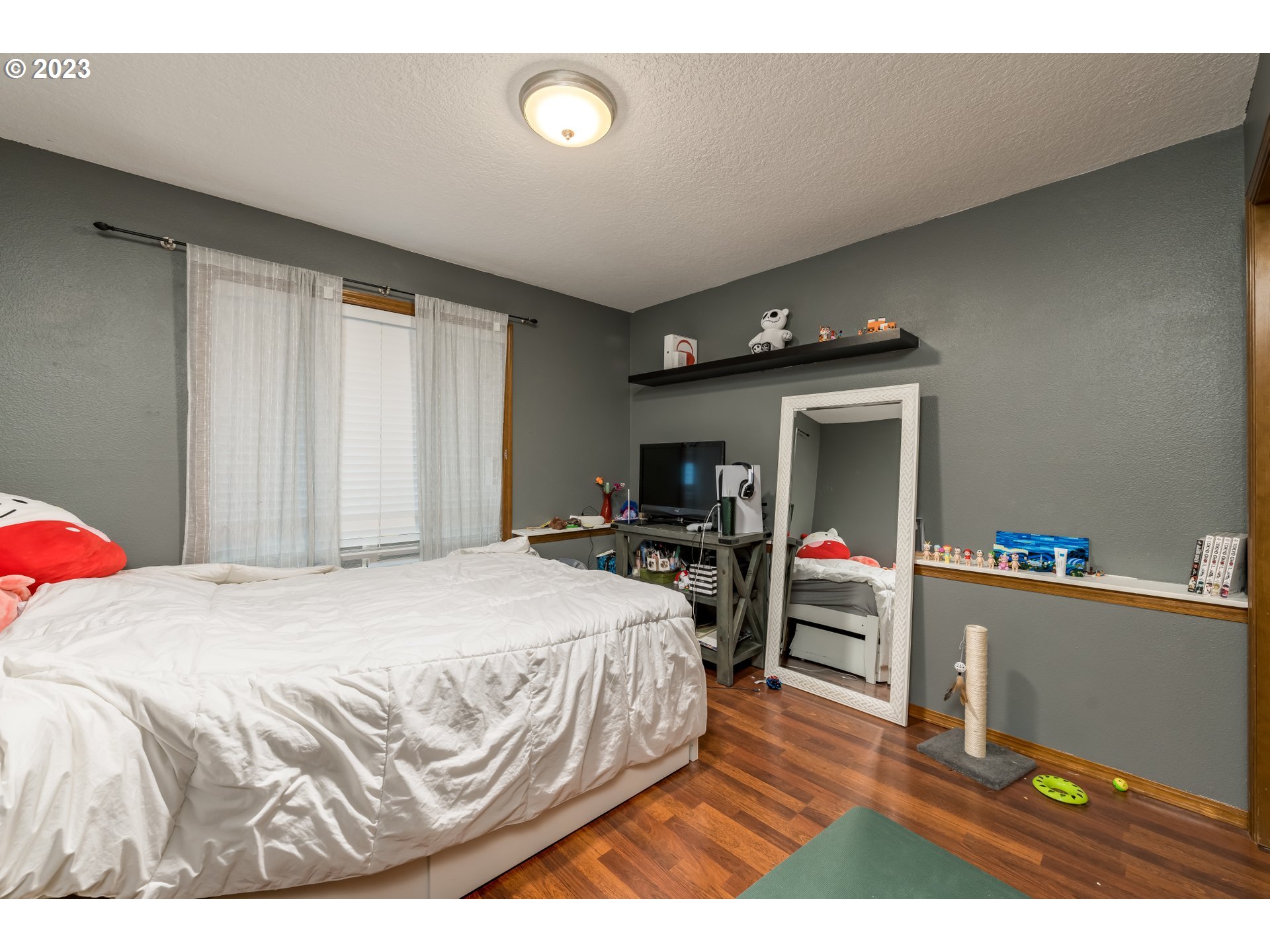 6428 Southwest 155th Avenue Beaverton, OR 97007 - Photo 15 of 24 a bedroom with a bed and a wooden floor