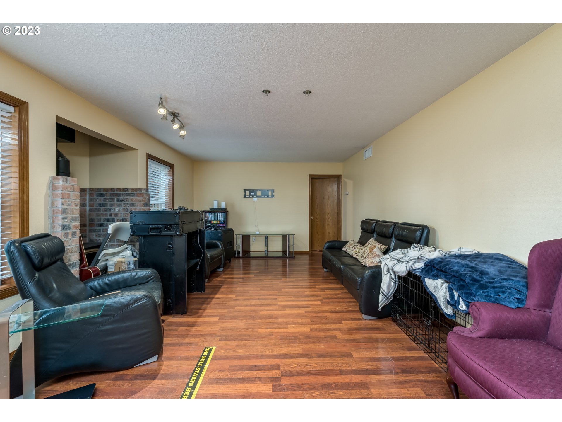 6428 Southwest 155th Avenue Beaverton, OR 97007 - Photo 16 of 24 a living room with furniture a fireplace and a flat screen tv