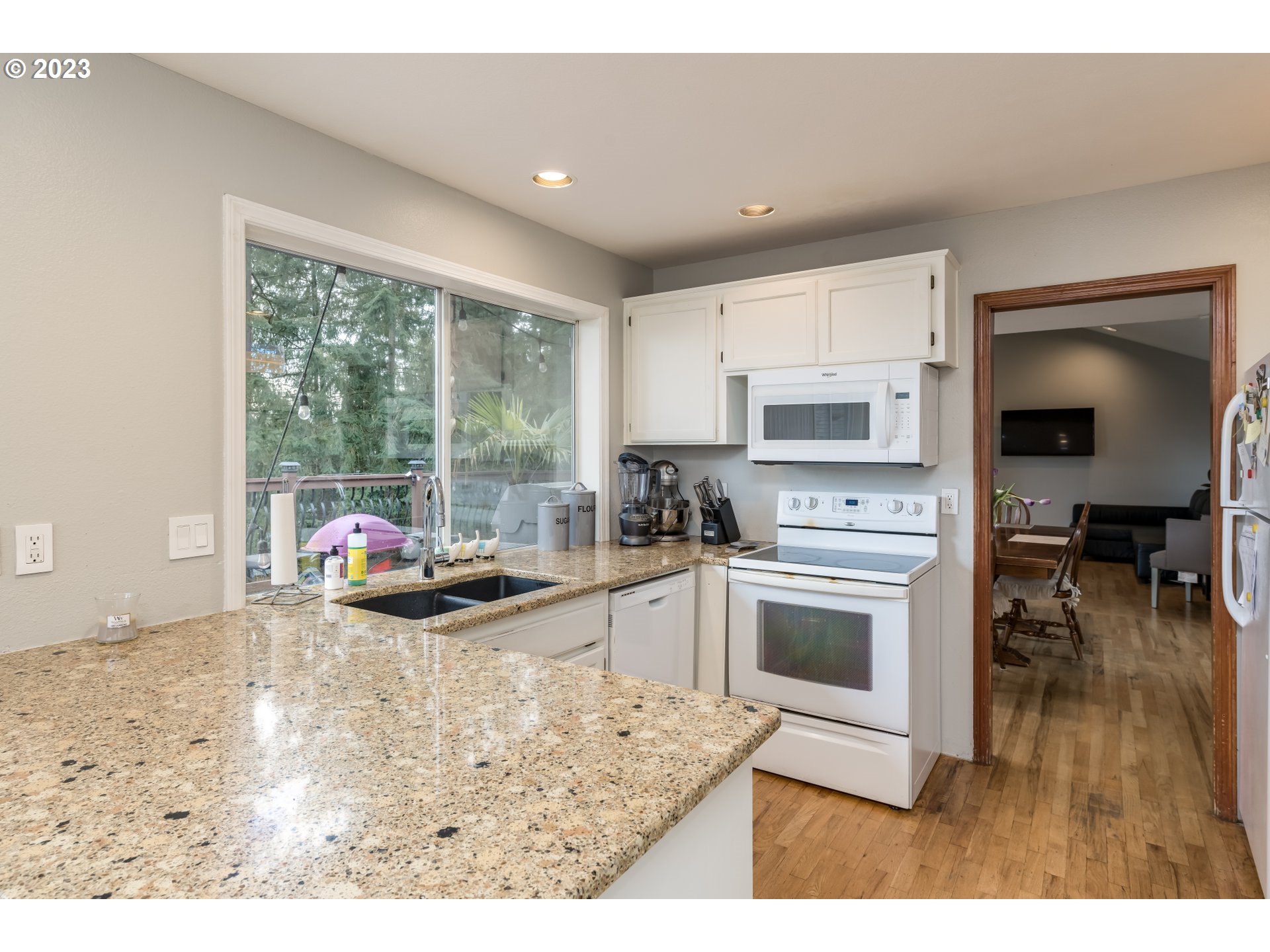 6428 Southwest 155th Avenue Beaverton, OR 97007 - Photo 3 of 24 a kitchen with sink a microwave and cabinets