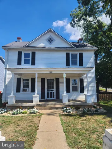 a front view of a house with swimming pool and glass windows