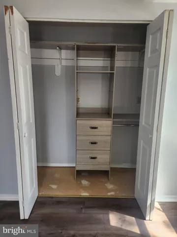 a view of walk in closet with empty racks